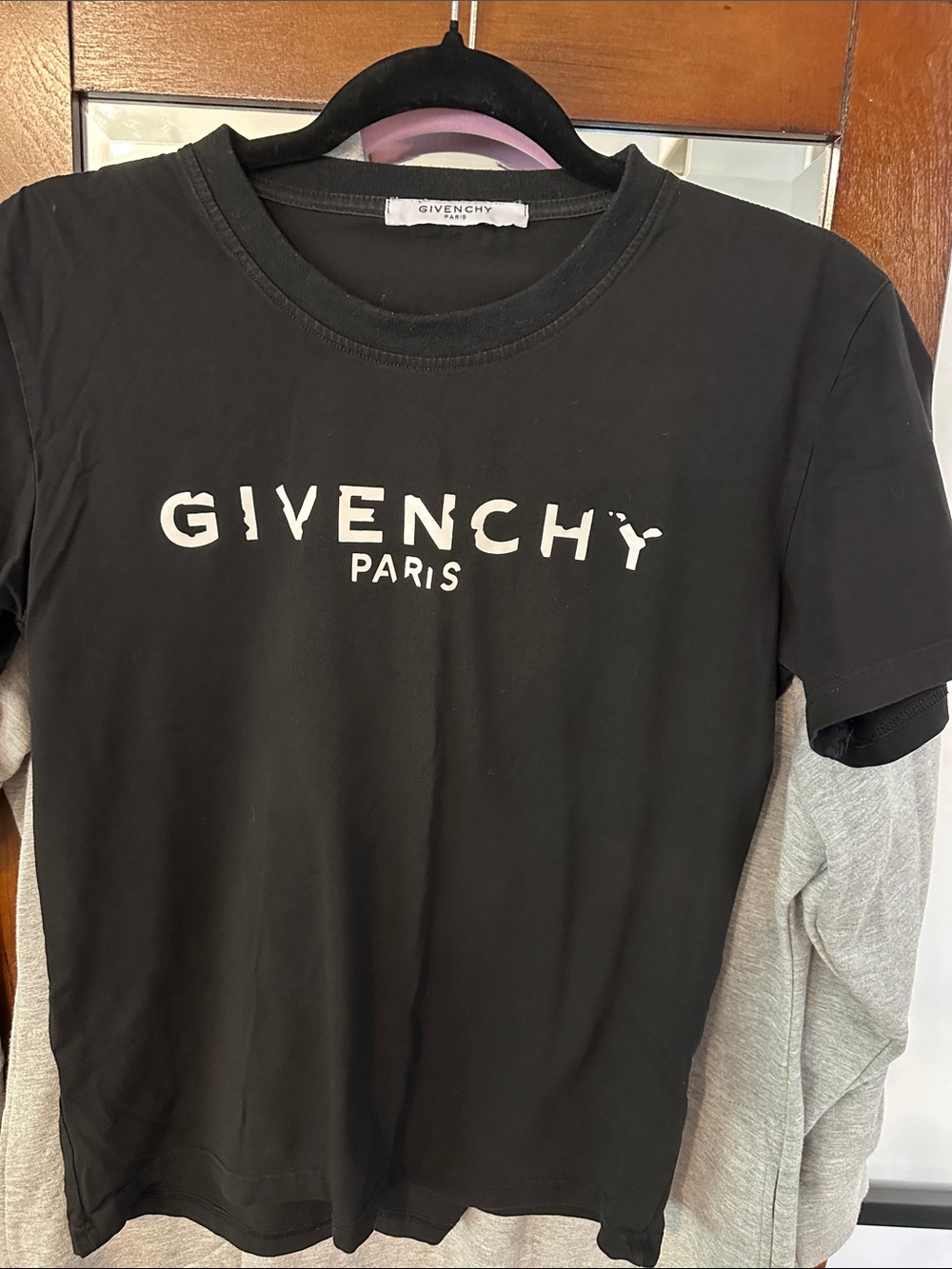 Givenchy Paris women’s black tee-shirt with distressed-effect logo.